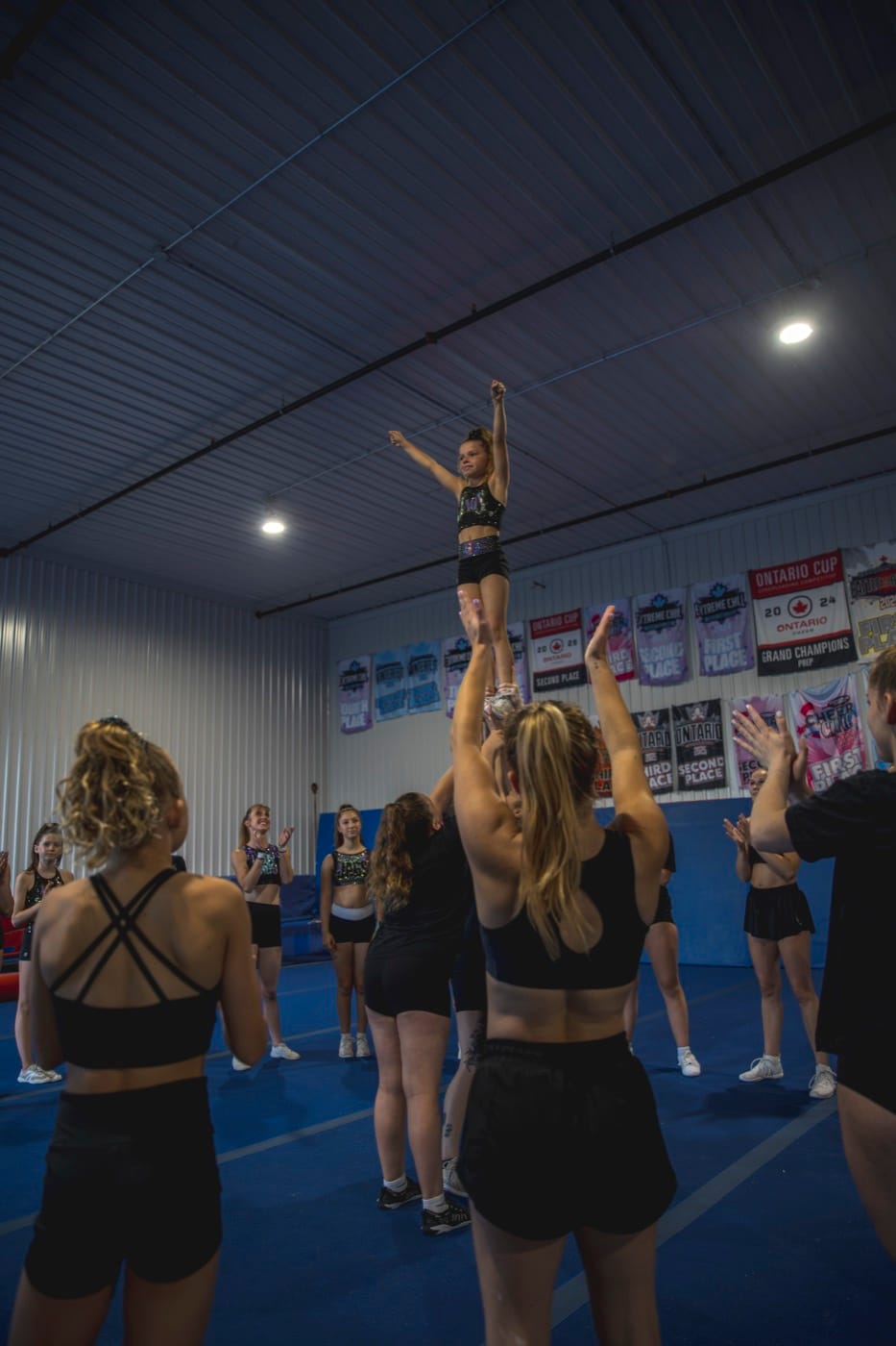 CheerCore Jags athlete being coached through a stunt