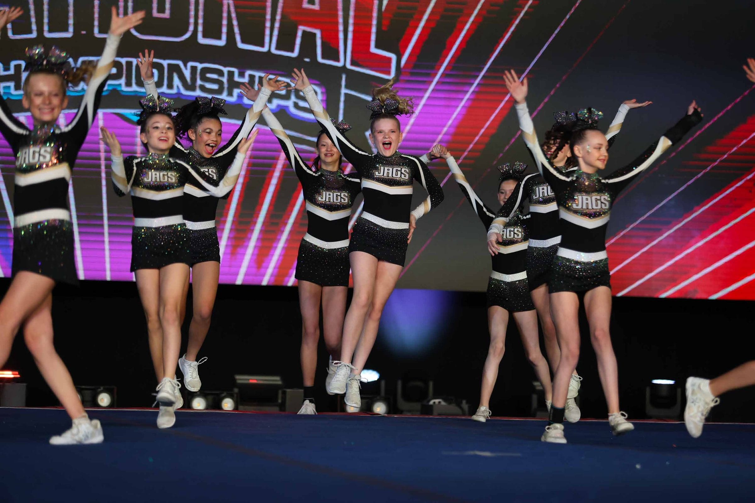 CheerCore Jags athletes performing on a competition stage