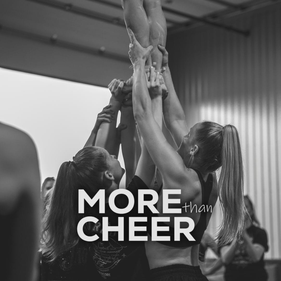 CheerCore Jags athletes holding a teammate overhead in a stunt during training