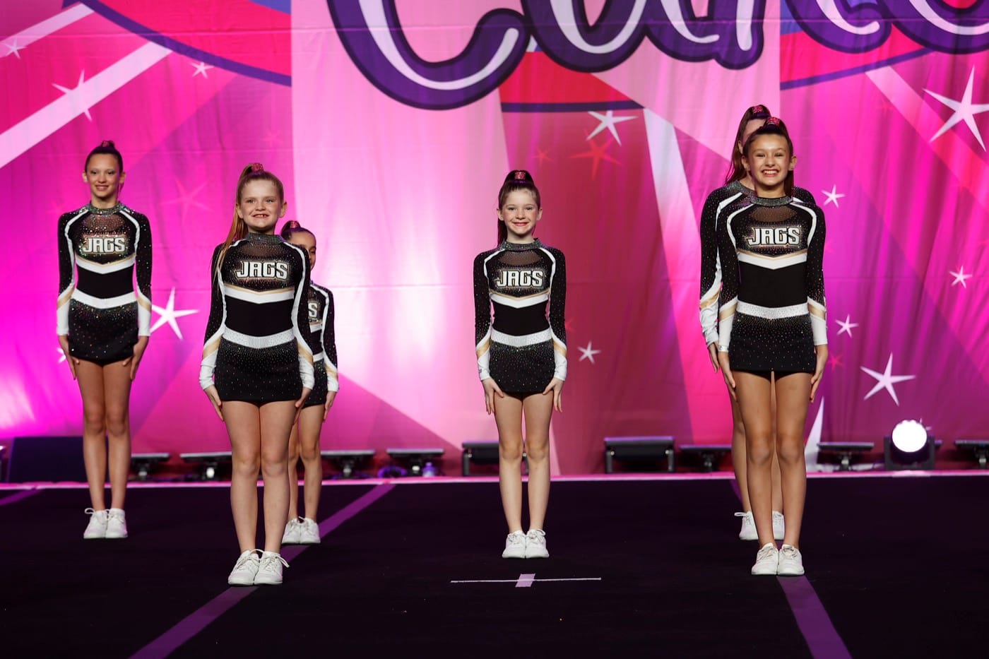 Prep Cheer team standing on stage in formation