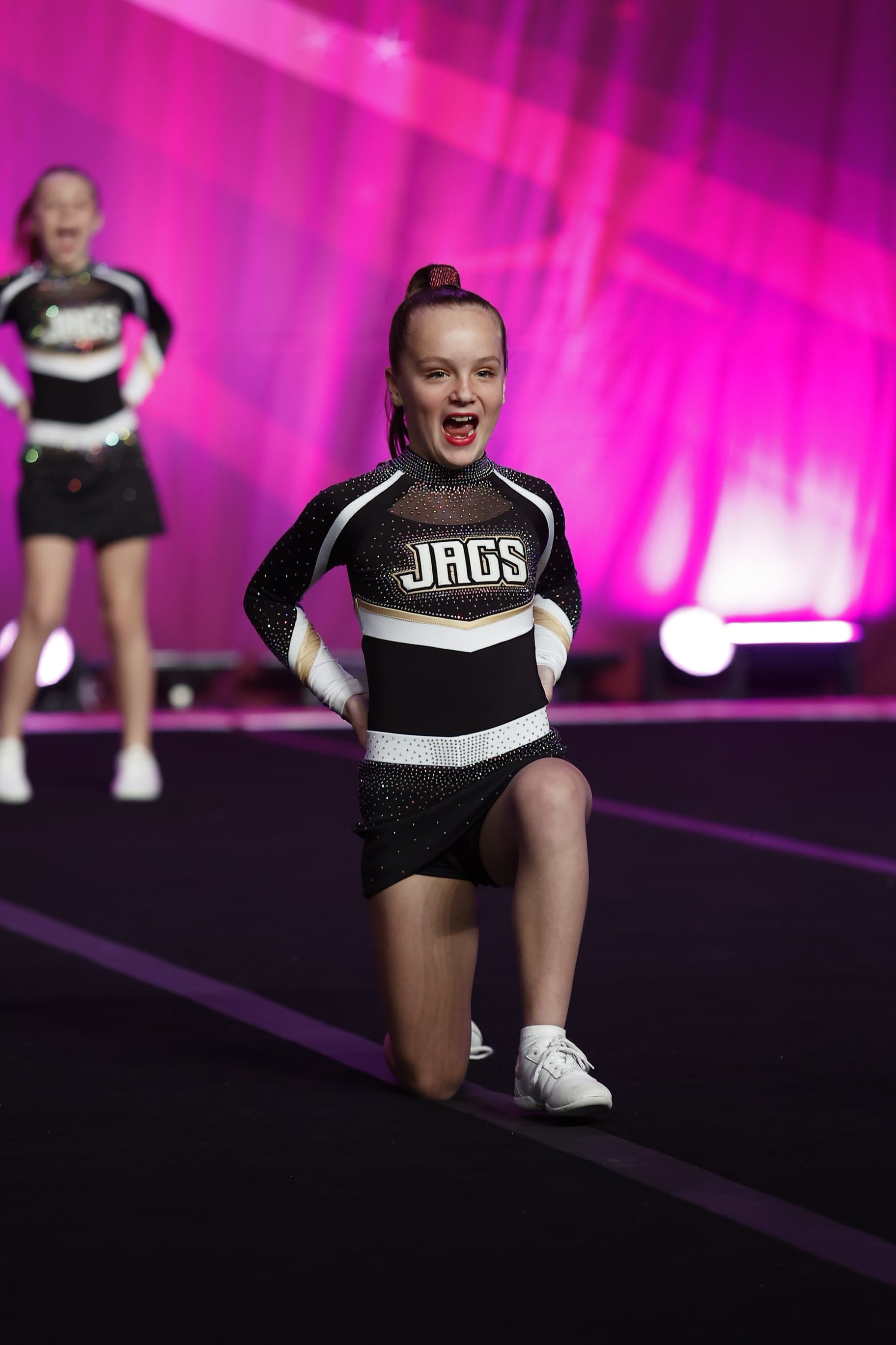 A Prep Cheer athlete performing a jump during her routine