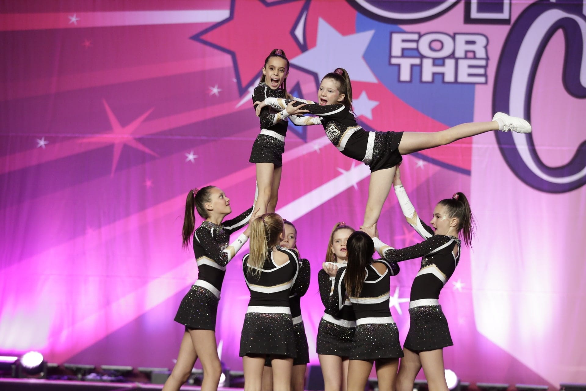 Prep Cheer athletes holding two flyers in a pyramid