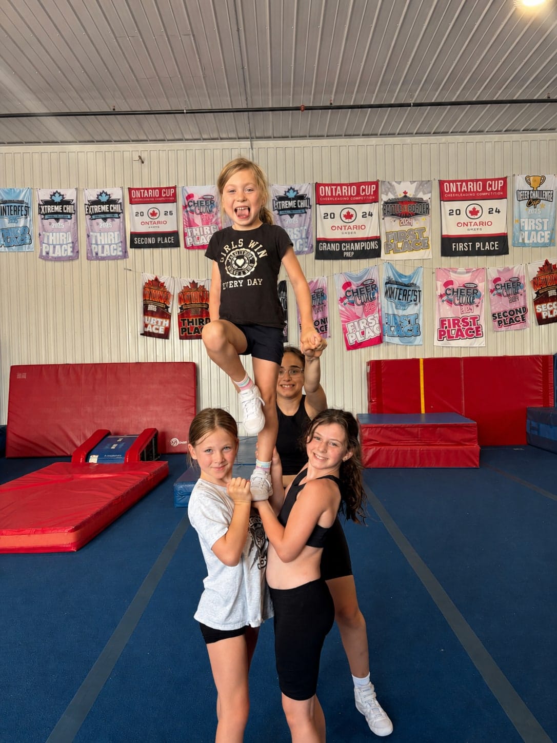 Young CheerCore Jags athletes holding a stunt at camp