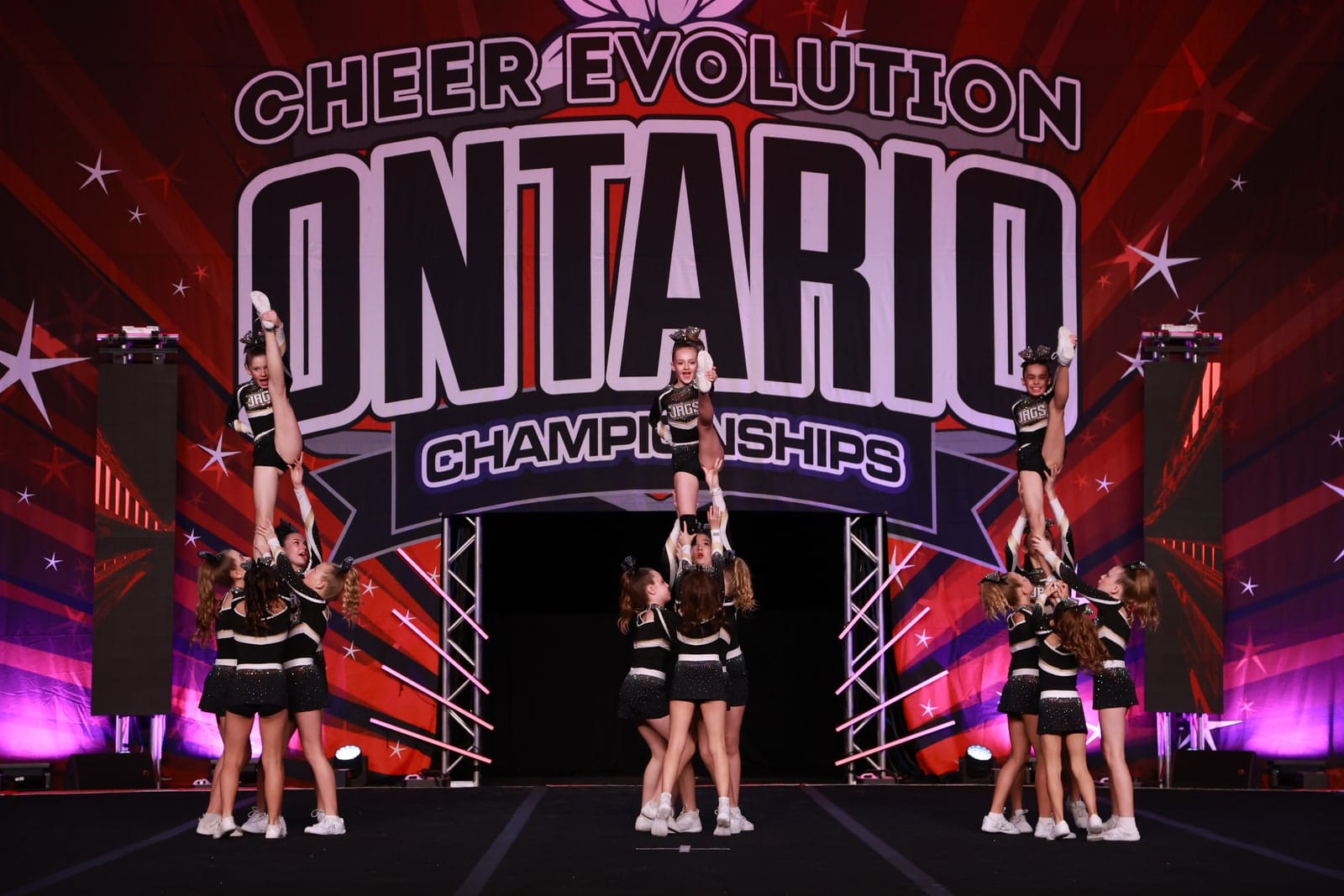 CheerCore Jags flyers hitting stretched stunts on the competition stage