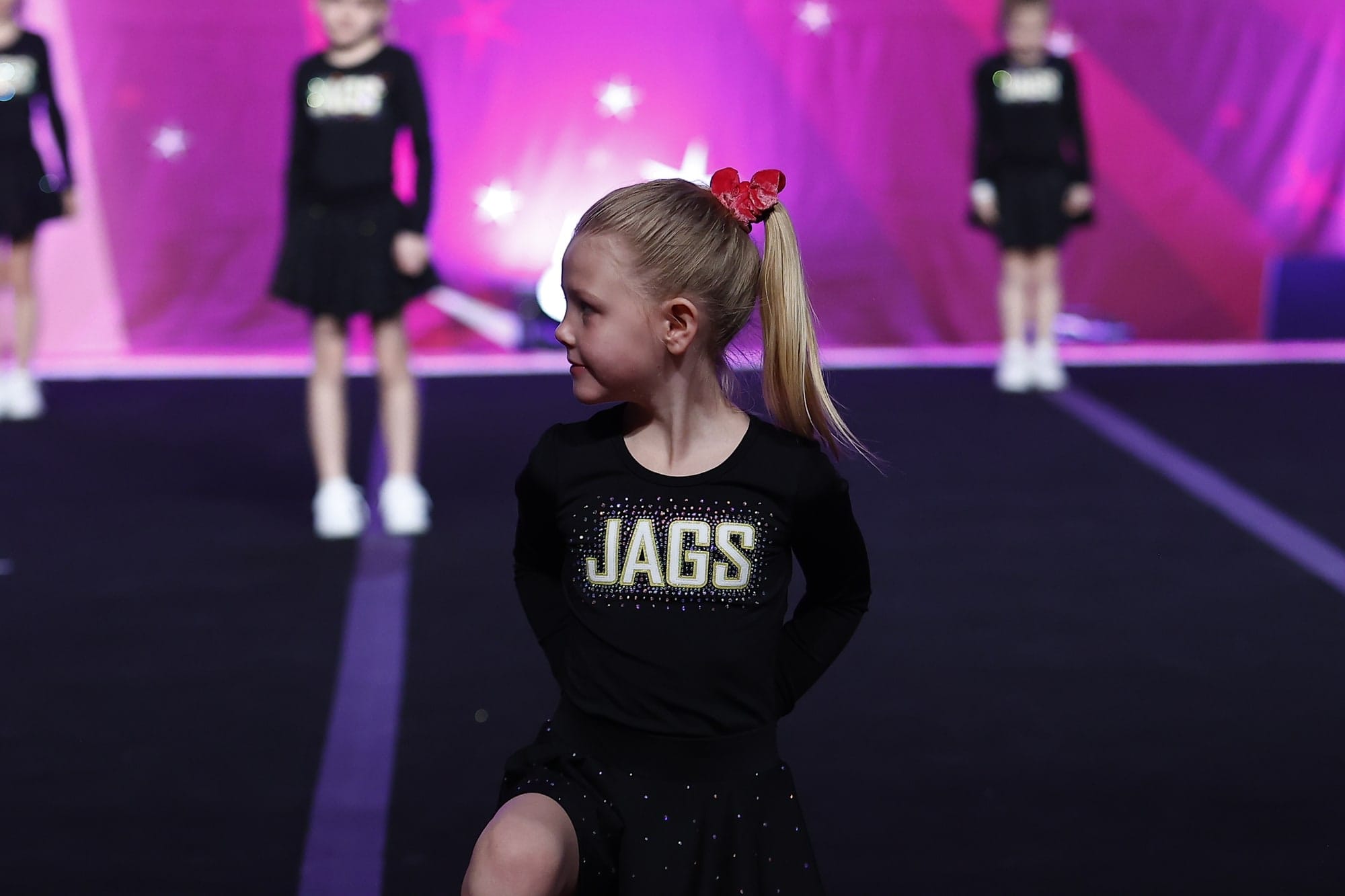 A Novice Cheer athlete performing in front of her teammates