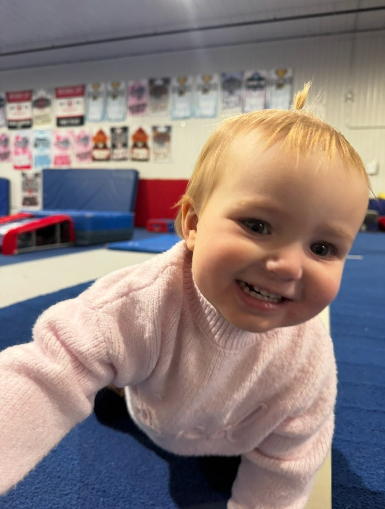A toddler crawling on the mats at a Parent and Tot class